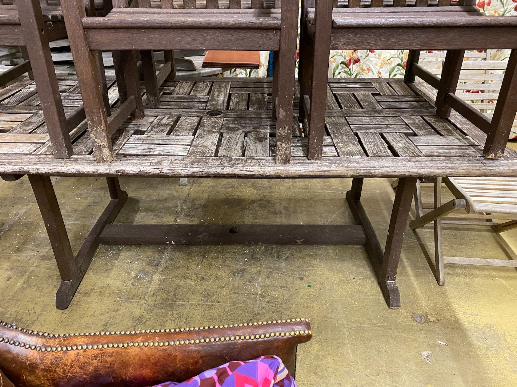 A rectangular weathered teak garden table, length 212cm, width 110cm, height 74cm and six elbow chairs by Alexander Rose